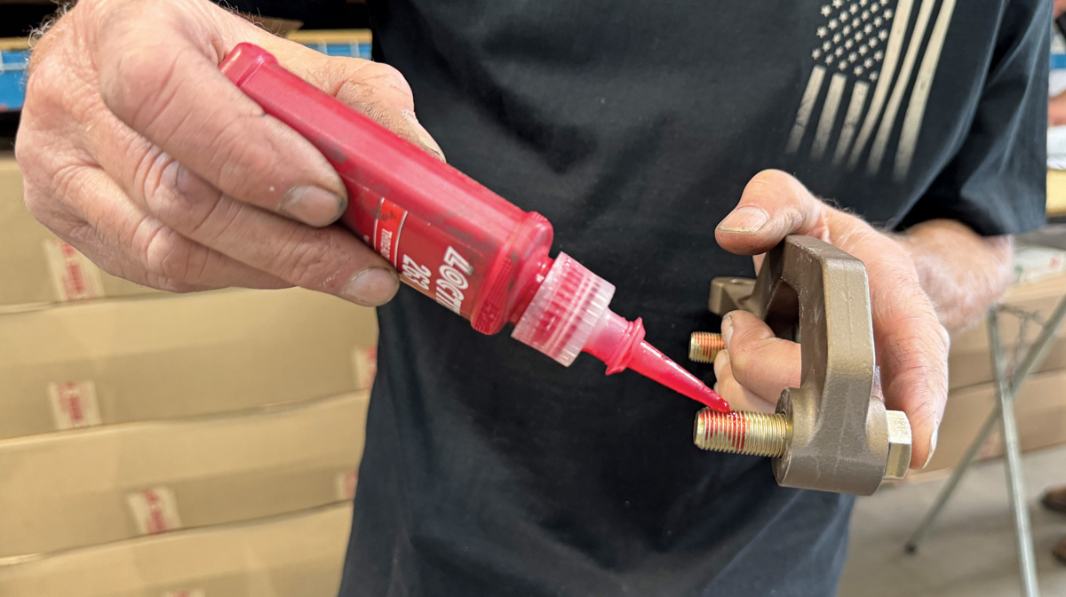 Applying Flatline Barriers insulation to the Camaro's floor for maximum soundproofing and thermal control