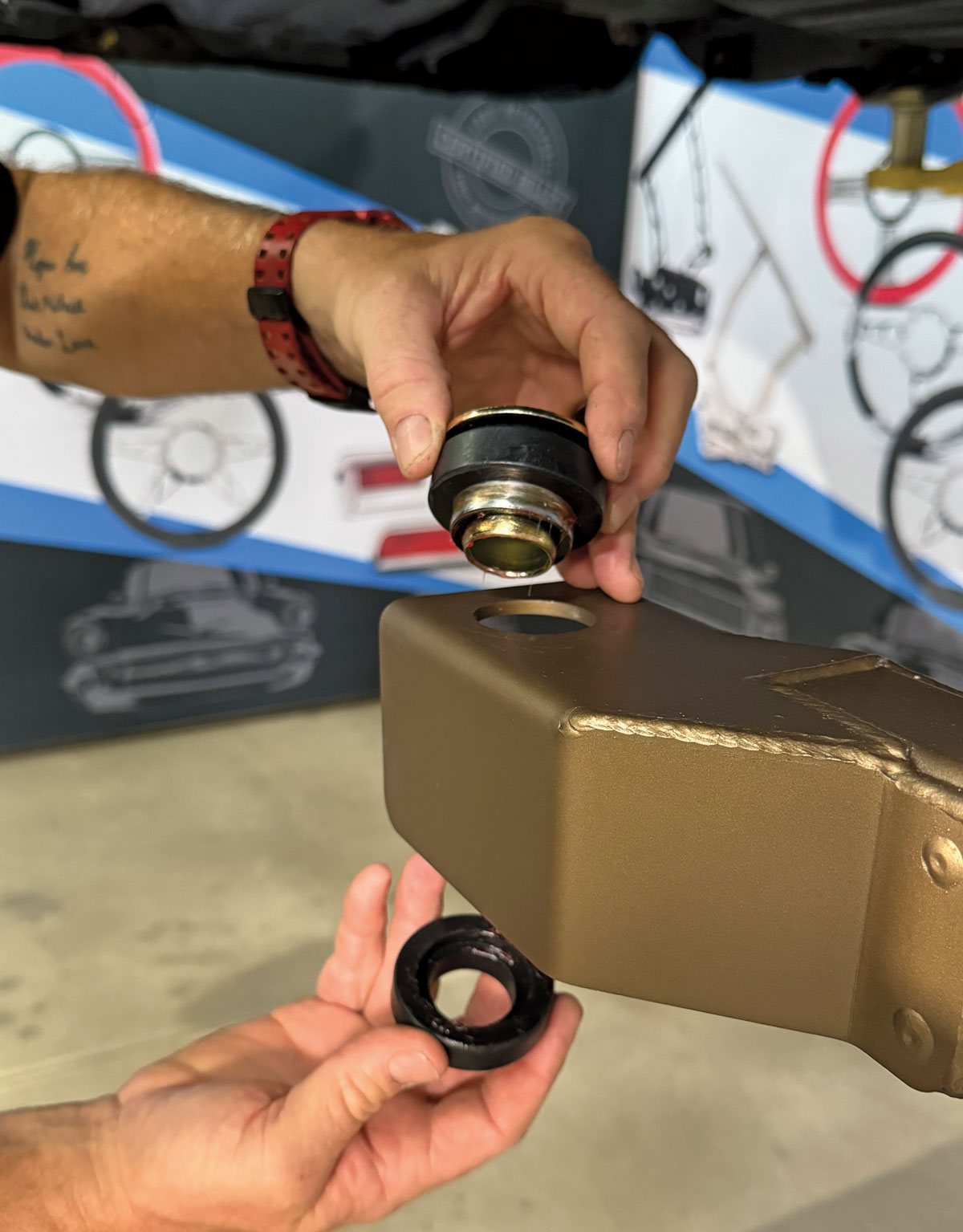 Inserting a bushing into a control arm for a Chevrolet Nova suspension assembly