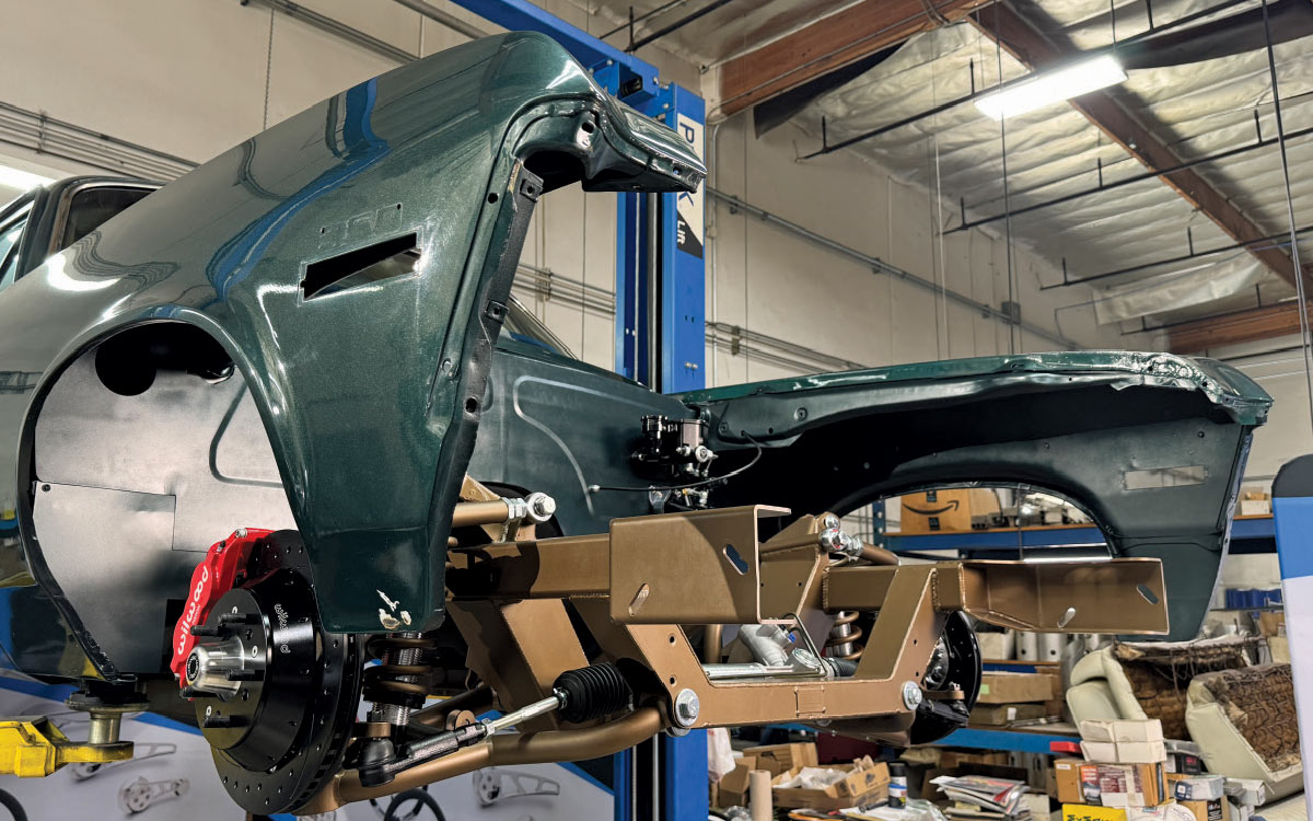 Front view of a Chevrolet Nova on a lift, showcasing a modern suspension and braking system upgrade