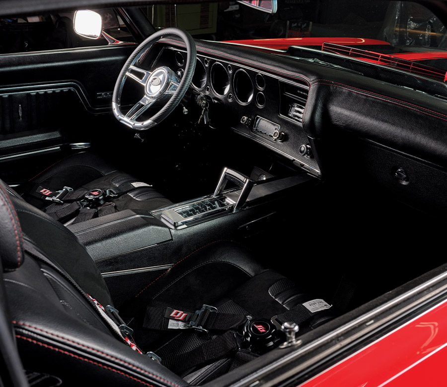 Interior shot of the 1970 Chevelle showing black leather seats and racing harnesses