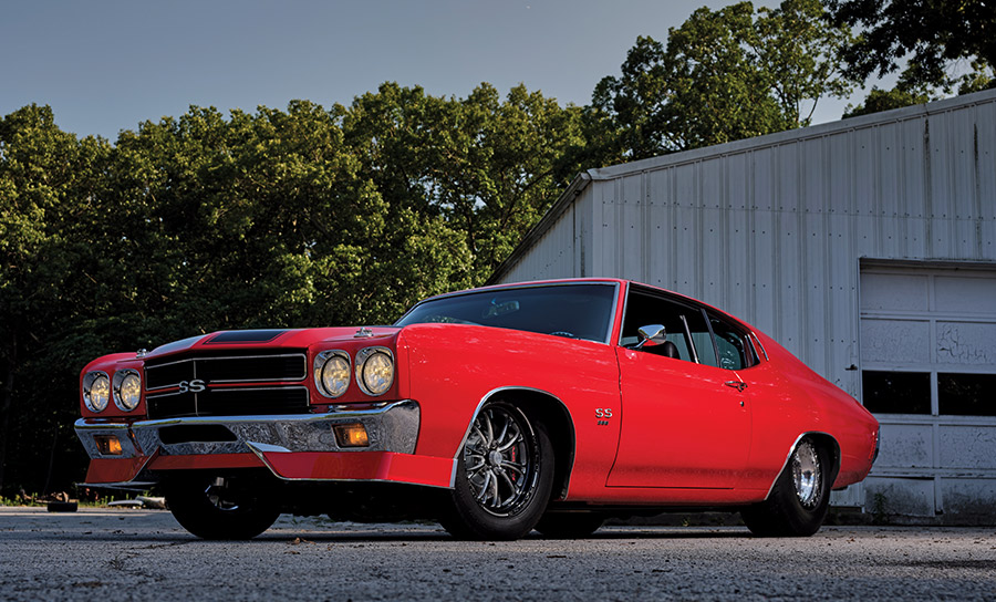Low-angle side shot of a 1970 Chevelle SS with a bright red paint job and black accents