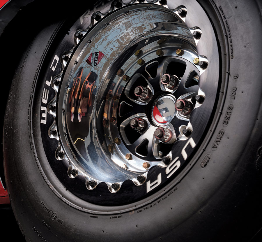 Polished Weld Racing rear wheel with USA branding on a drag tire