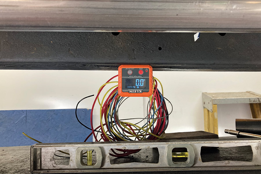 Digital protractor measuring the exhaust pipe's angle for precise installation