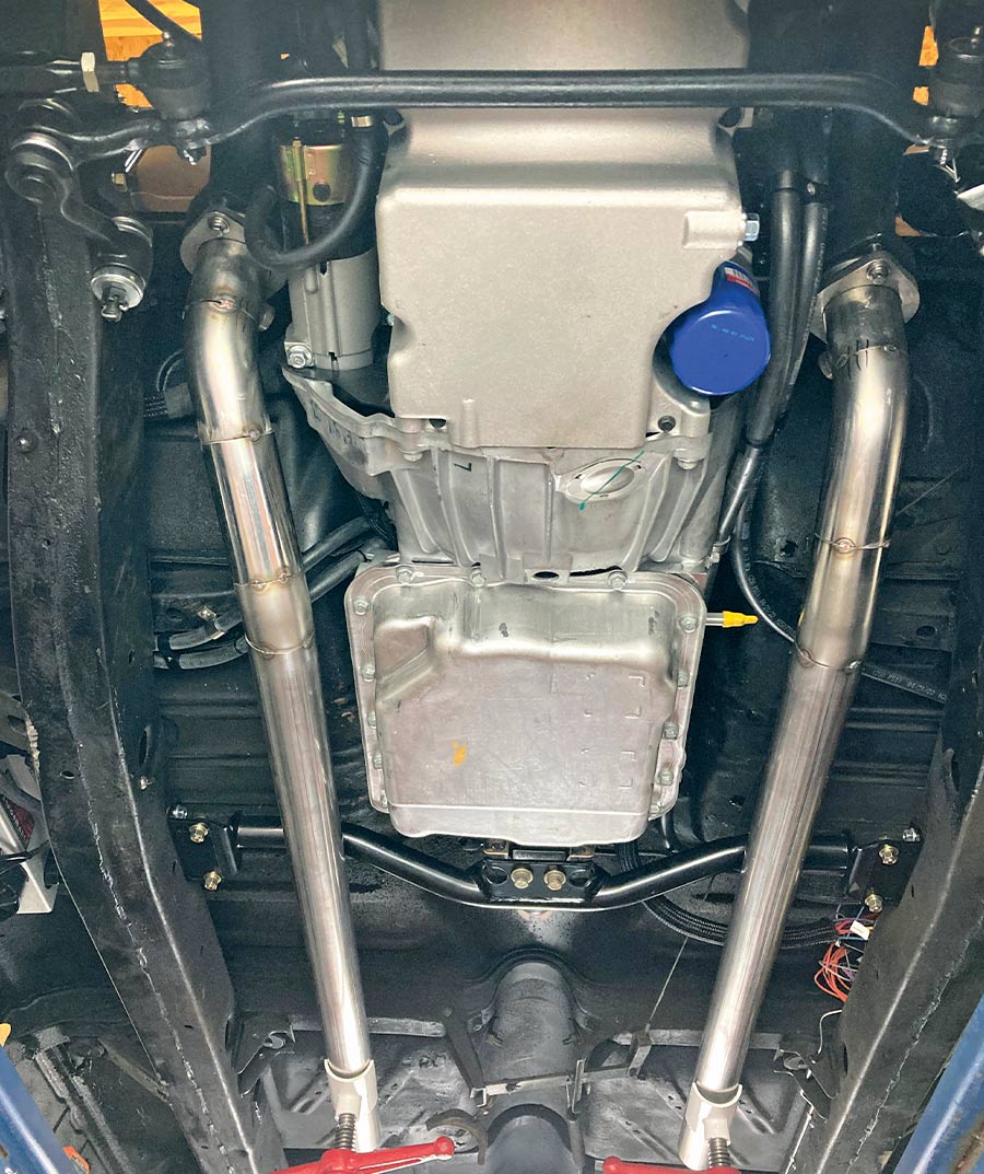 Stainless steel dual exhaust system fully installed, viewed from under the car's chassis