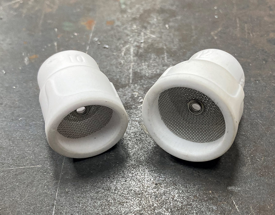 Two white ceramic gas lenses for a TIG torch, with mesh screens inside