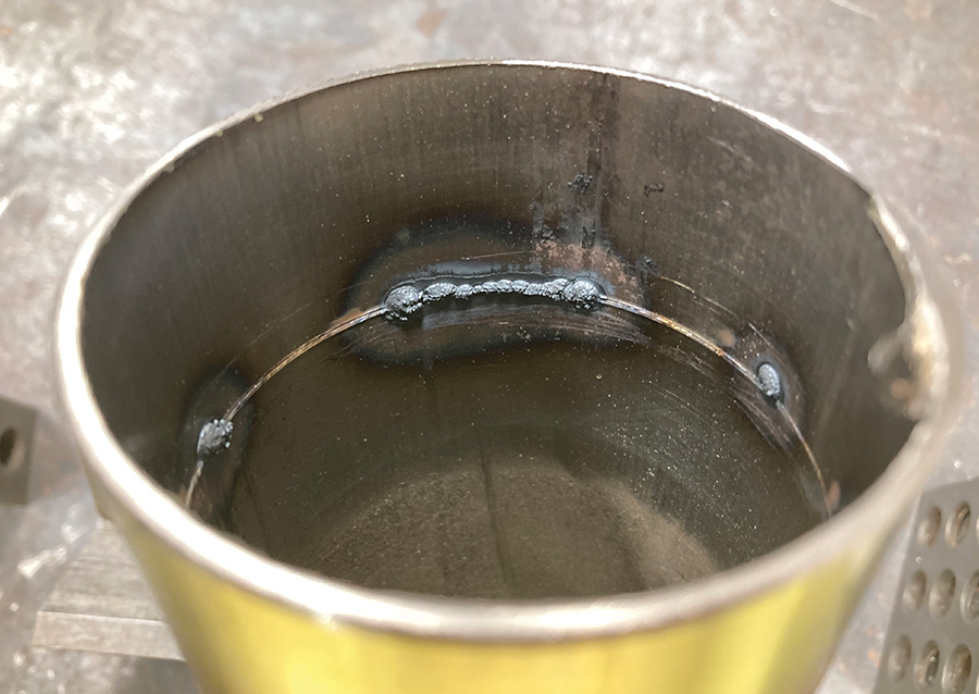 Interior weld bead inside a cylindrical pipe, showcasing TIG welding on stainless steel