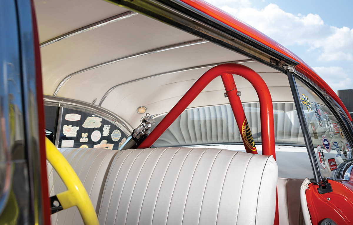 red roll cage and white interior upholstery with racing decals in the 1957 Chevy Bel-Air gasser