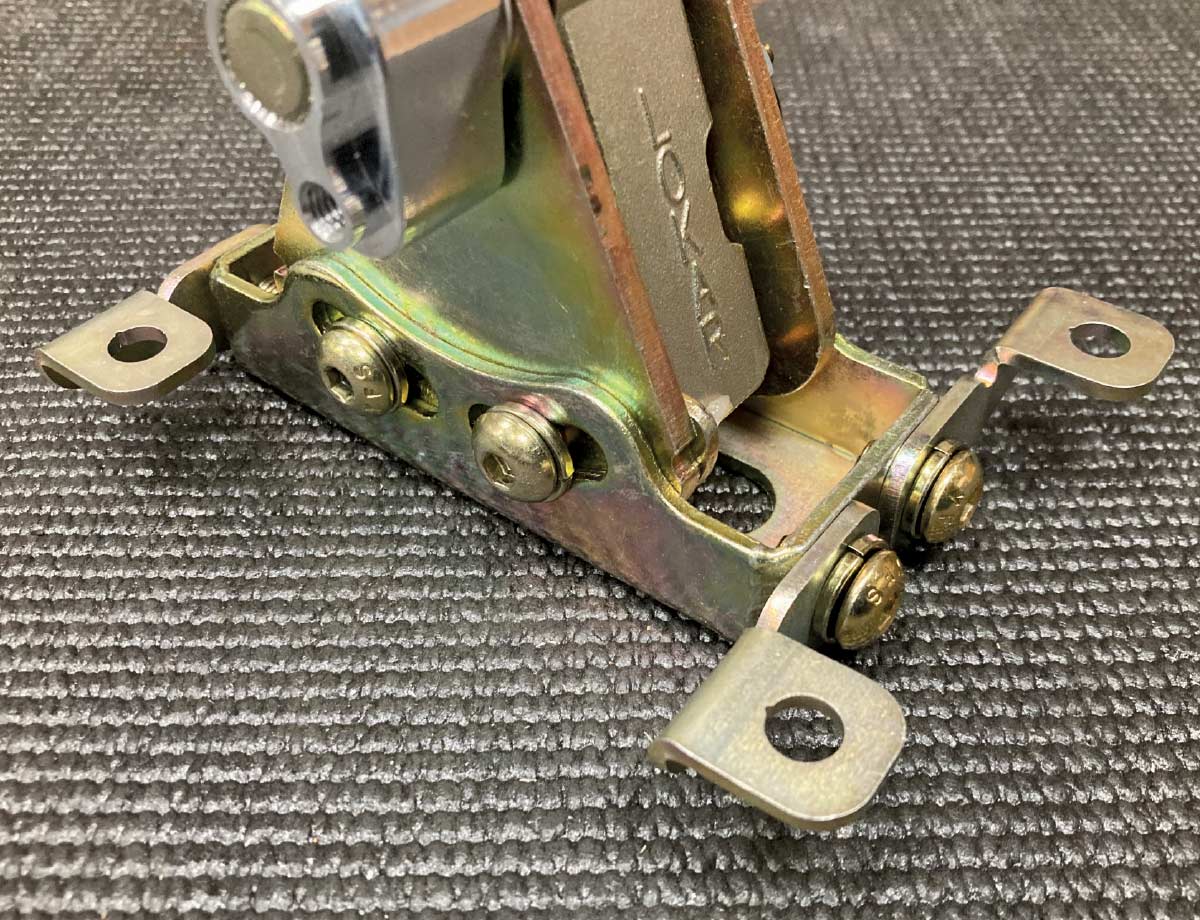 1957 Chevy Lokar shifter base securely attached with gold zinc mounting brackets