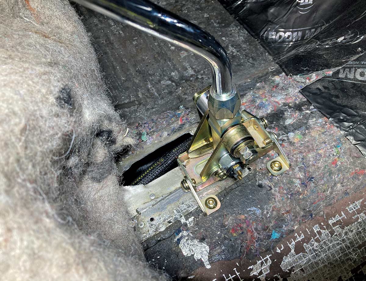 1957 Chevy Lokar shifter in progress, mounted through interior floor with insulation visible