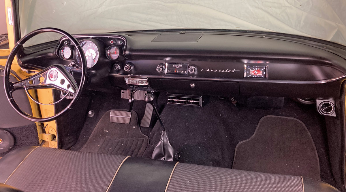 1957 Chevrolet interior dash with vintage steering wheel and restored gauges