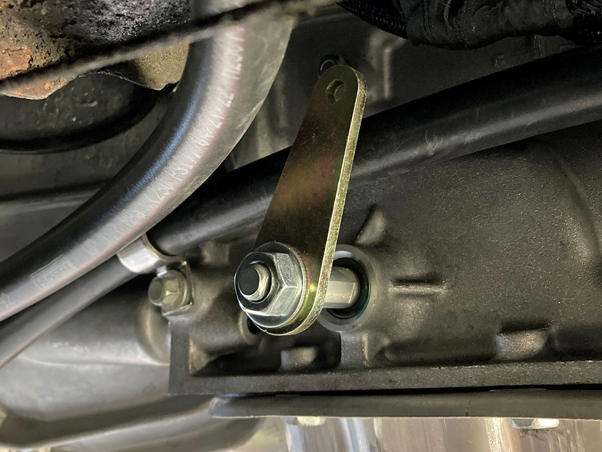 1957 Chevy Lokar transmission linkage connected to Supermatic transmission for reliable shifting