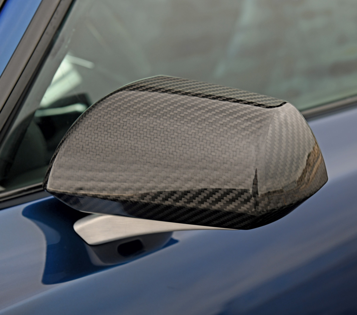 closeup of side mirror on dark blue 1969 chevy camaro
