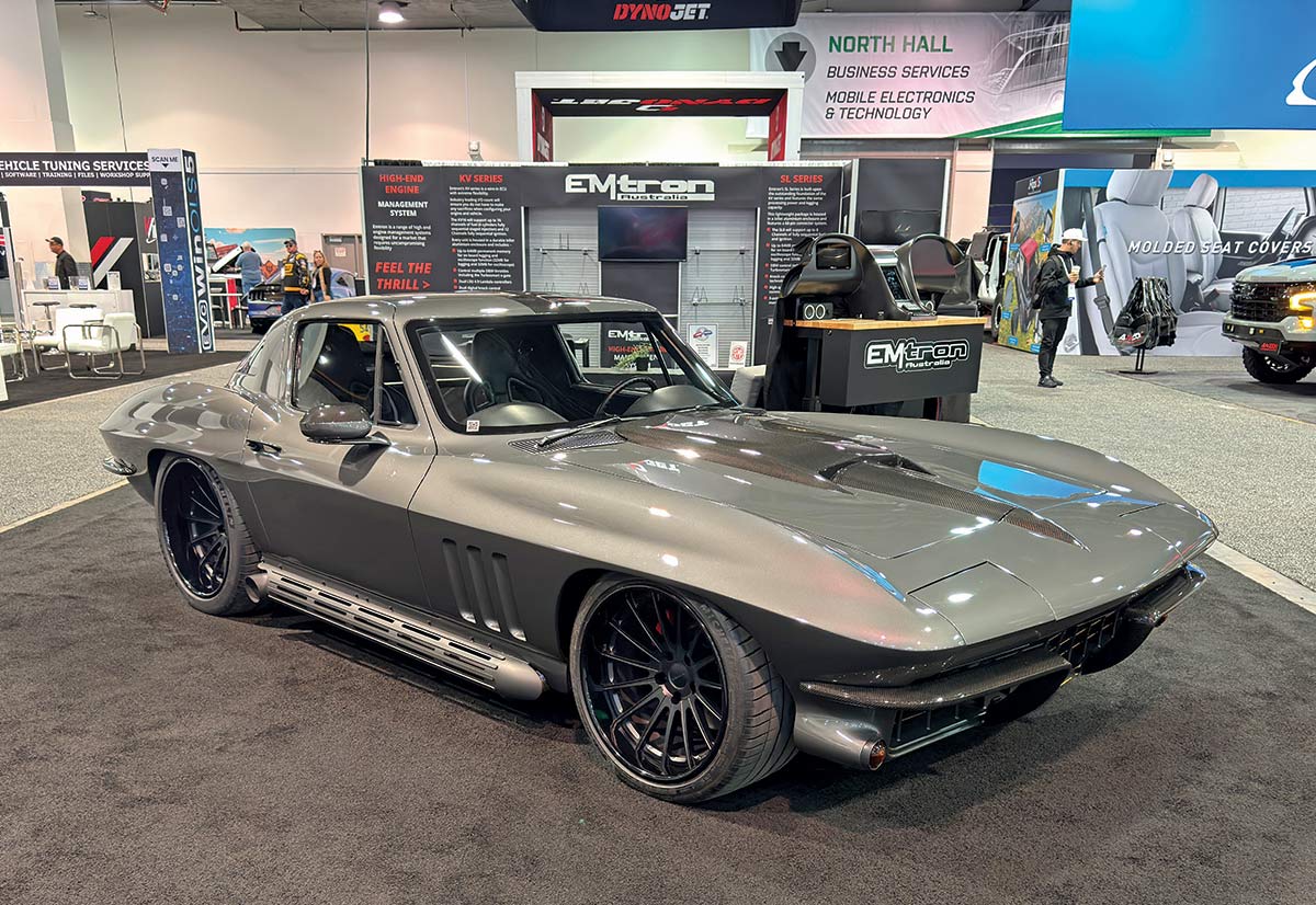 1965 Chevrolet Corvette gray restomod with carbon accents and side pipes at SEMA