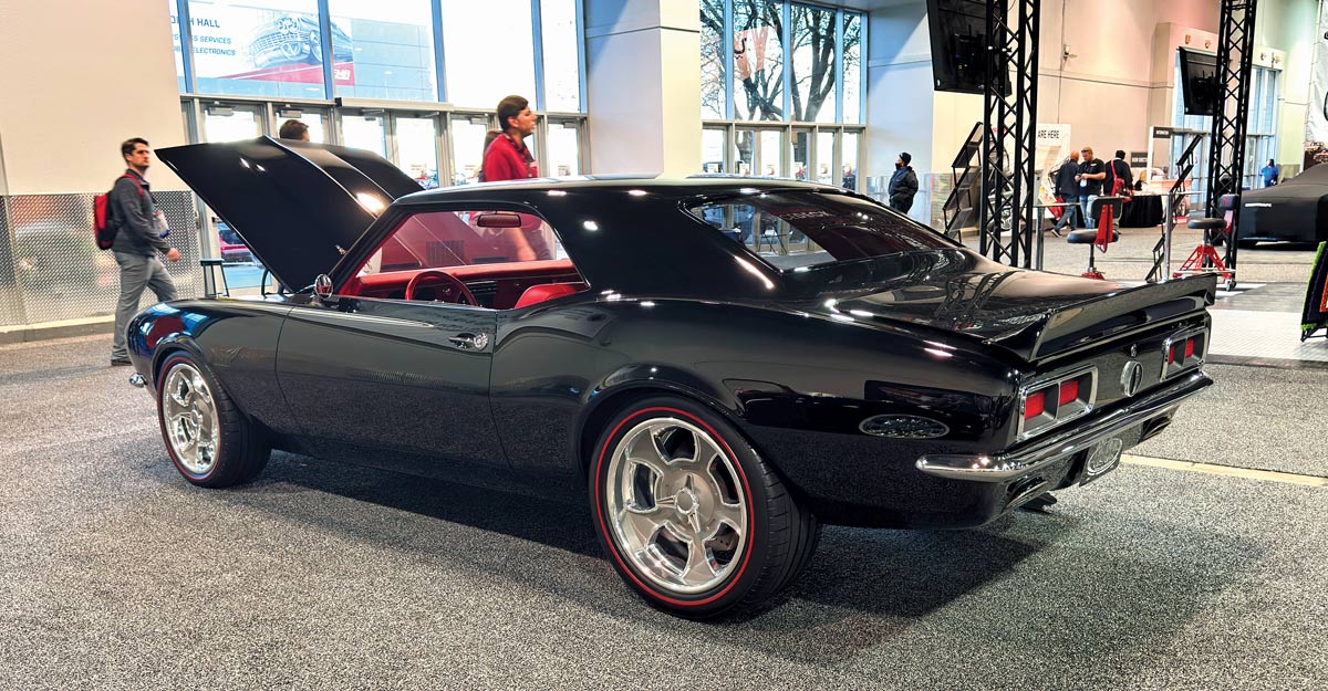 1968 Chevy Camaro black pro-touring build with red accents on display at SEMA