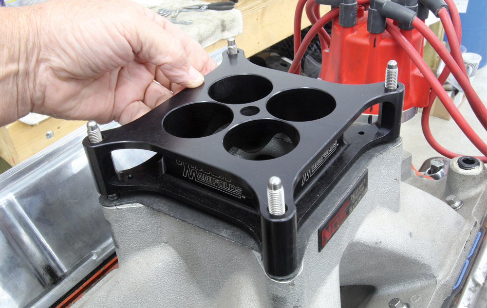 Installing a spacer plate on the intake manifold of a Chevy small block engine