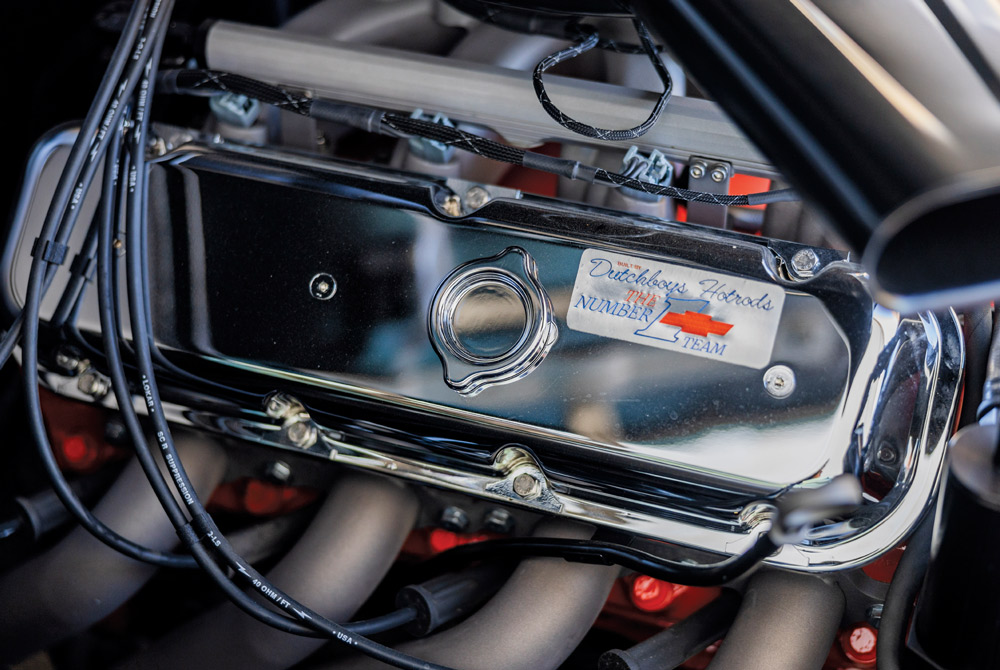 Close-up of a chrome engine valve cover with an oil cap and label.