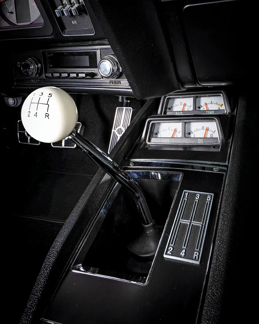 1969 Chevy Camaro center console with manual shifter and retro gauges