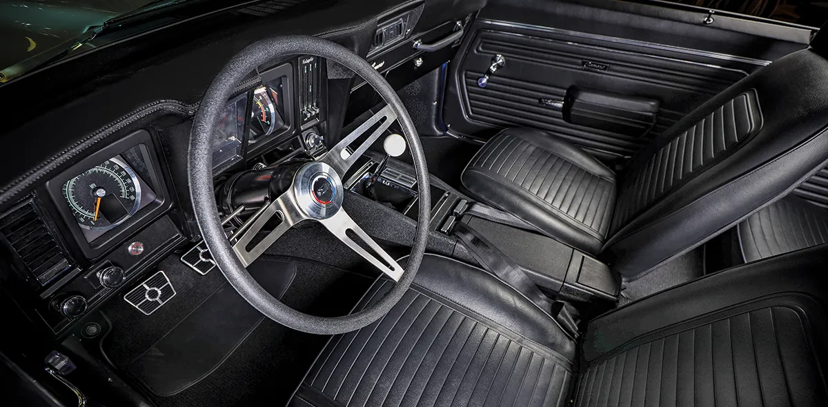 1969 Chevy Camaro interior with classic black upholstery and vintage steering wheel design