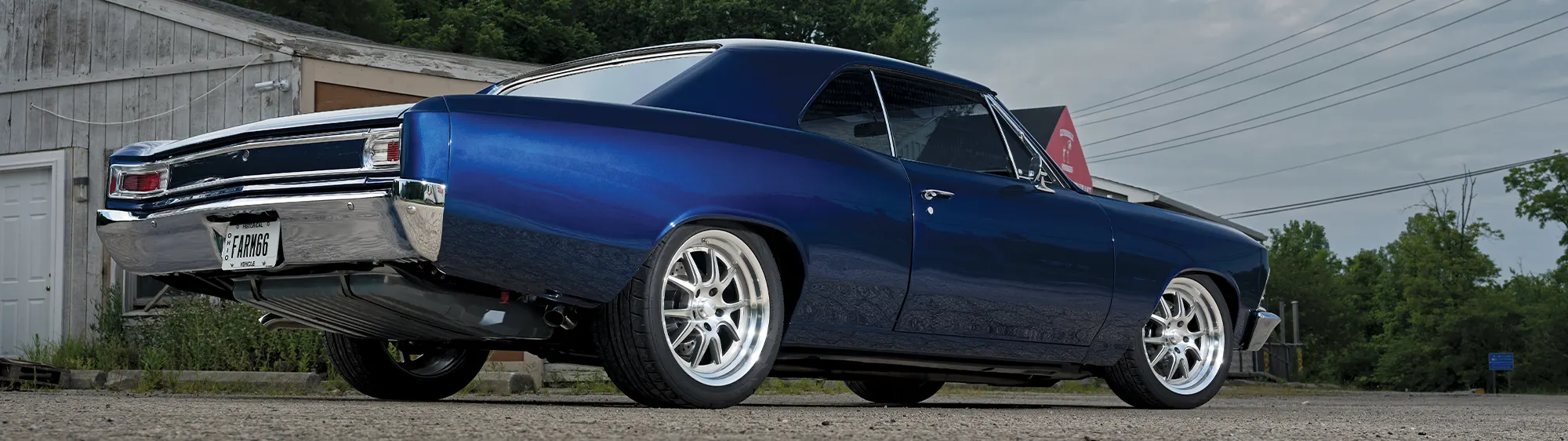 1966 Chevy Chevelle restomod, blue metallic paint, lowered stance, polished custom wheels, and modern upgrades