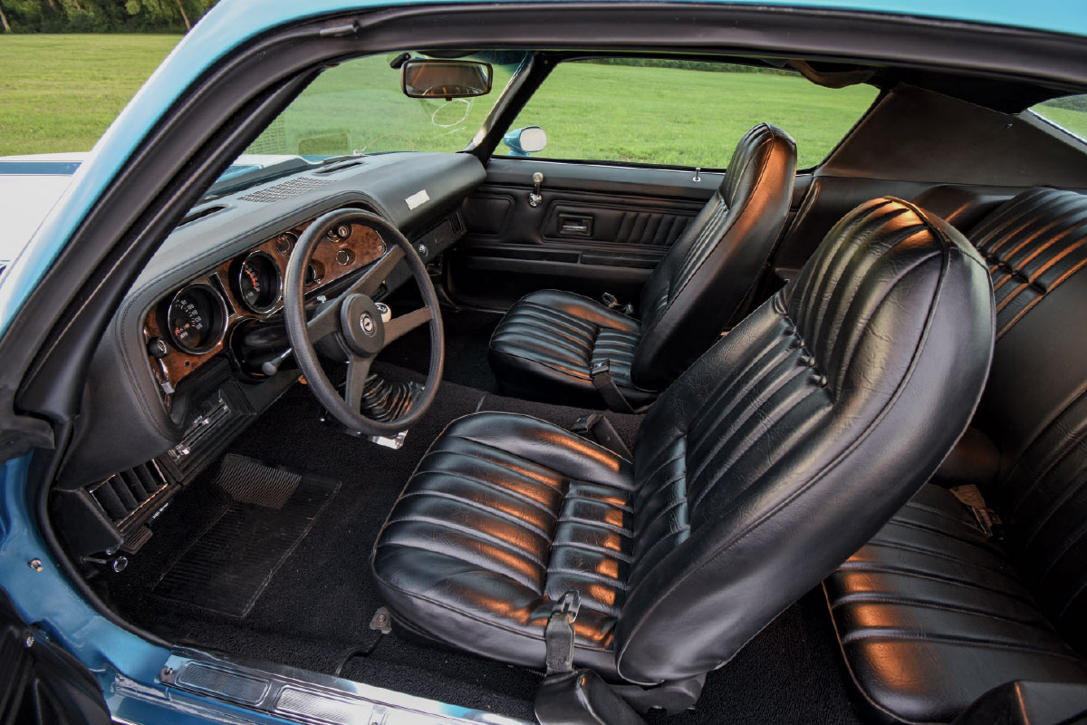 1972 Chevy Camaro interior with black vinyl bucket seats and woodgrain dash trim