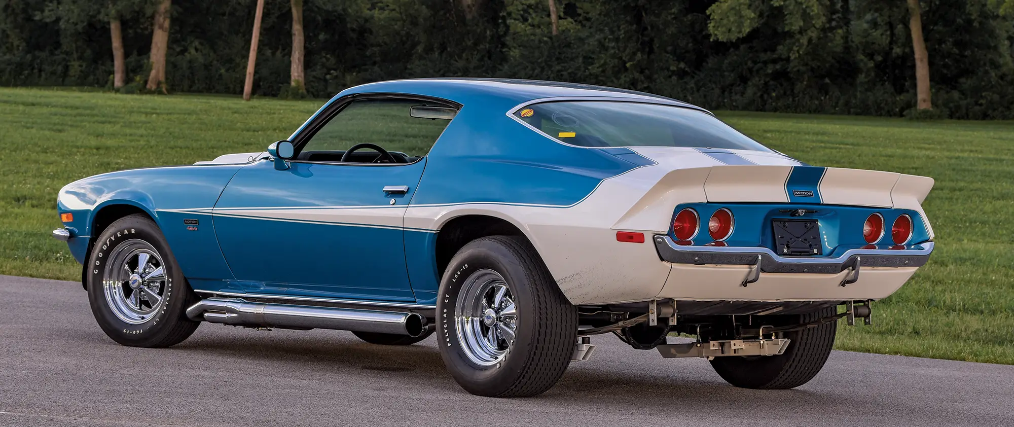 1972 Chevy Camaro rear three-quarter view with white stripes and chrome side pipes