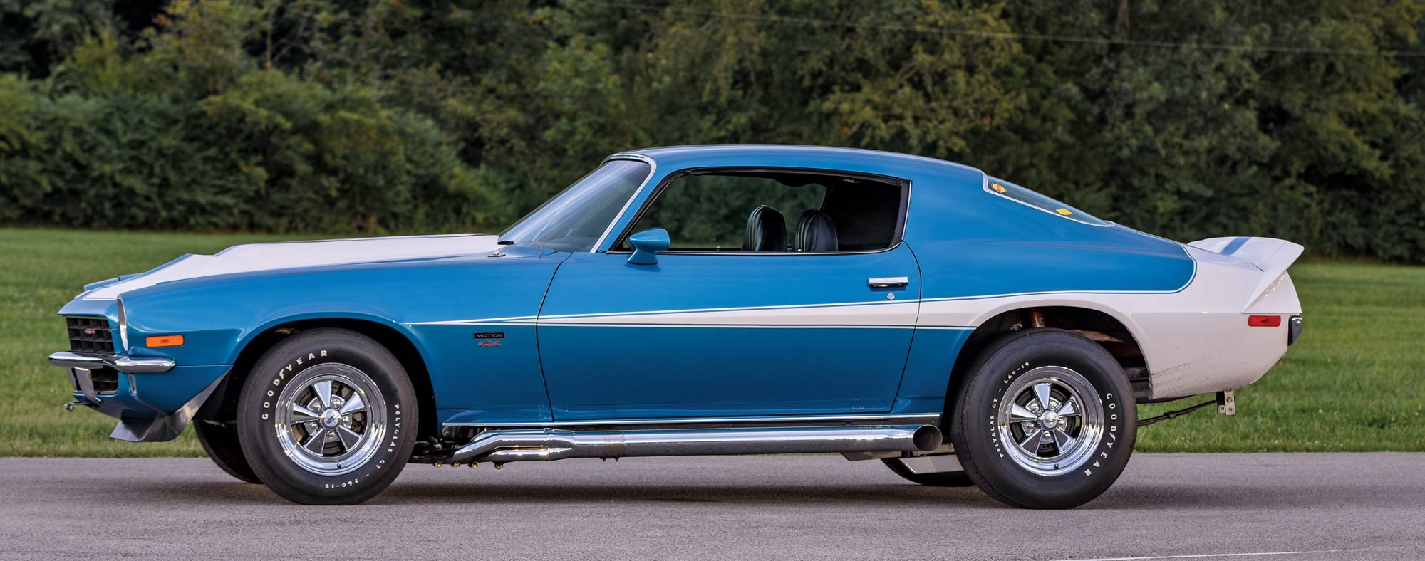 1972 Chevy Camaro side profile with blue and white paint and Goodyear tires