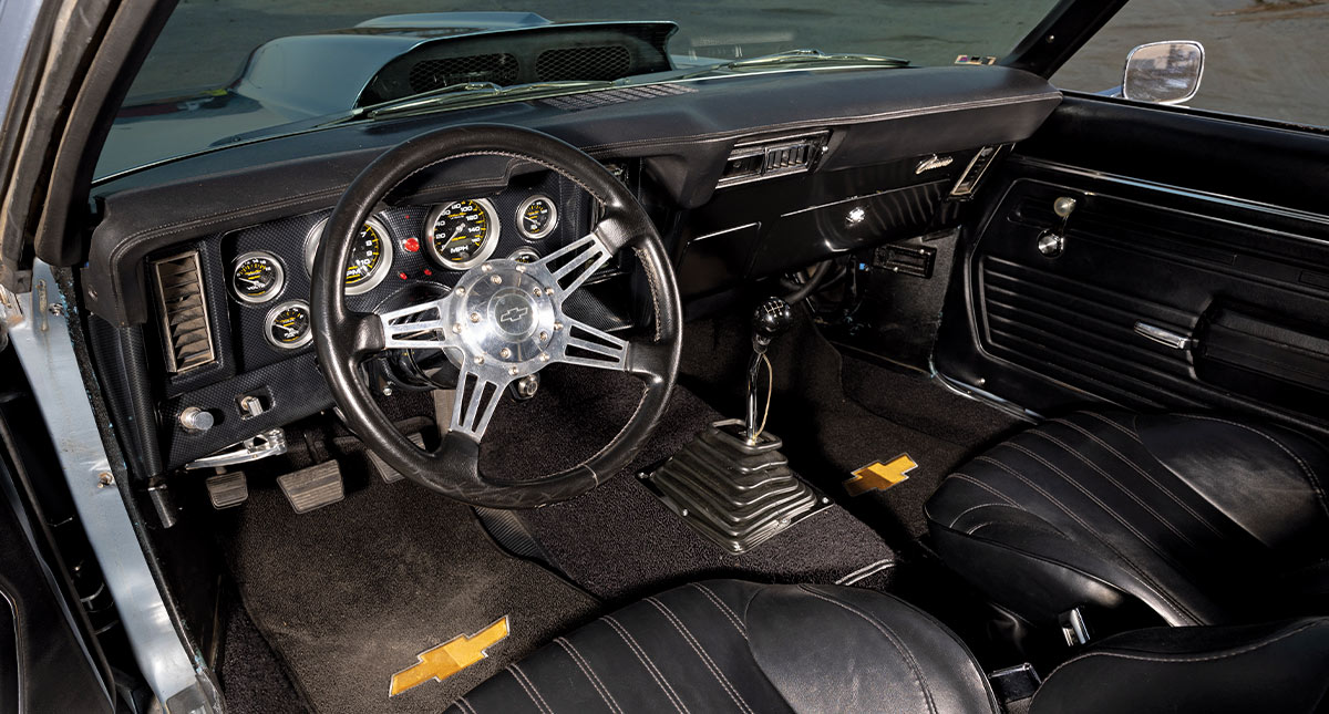 1969 Chevy Camaro with classic black bucket seats and retro-modern interior