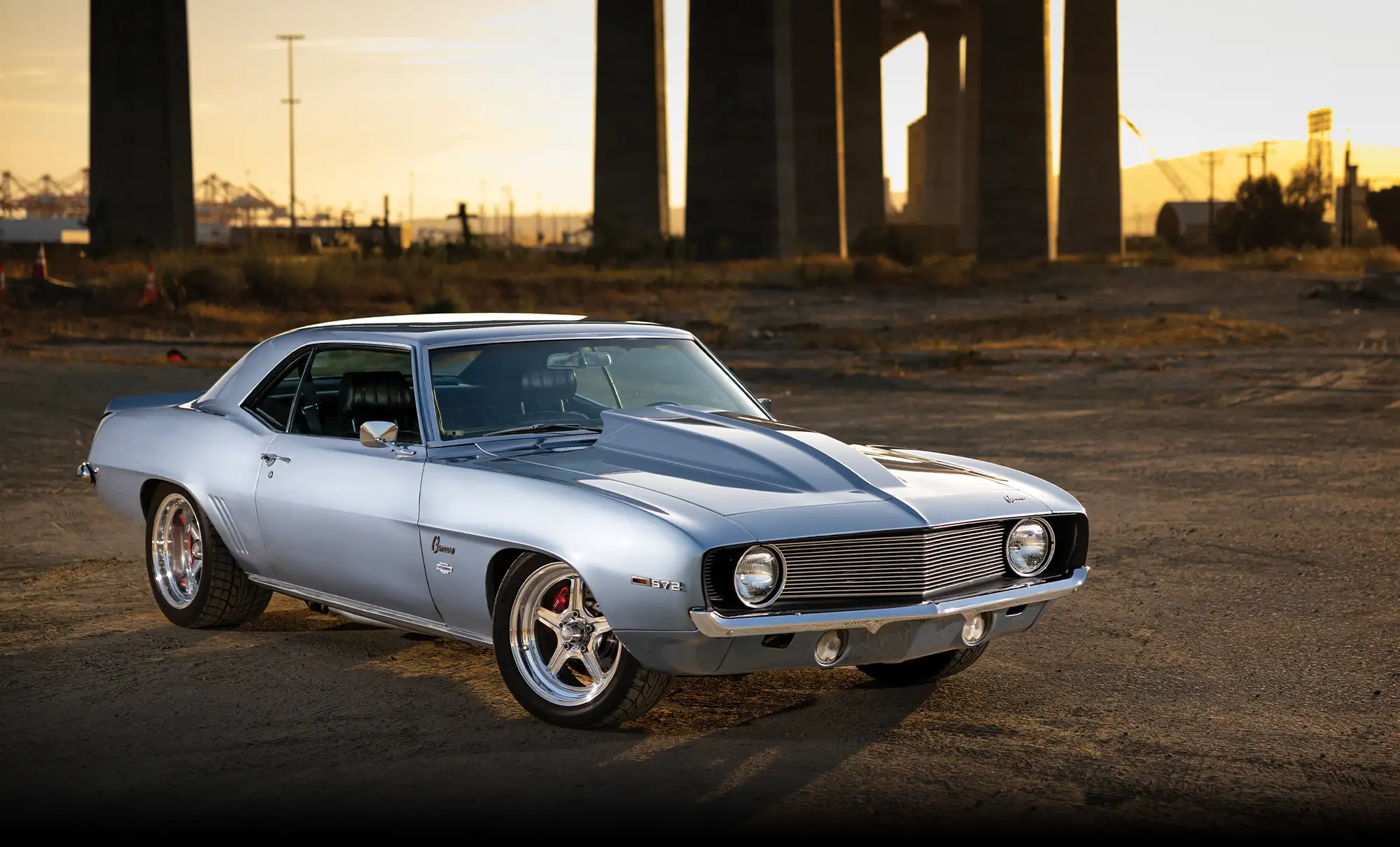 1969 Chevrolet Camaro showcases an aggressive hood scoop and custom grille, emphasizing its pro-touring style
