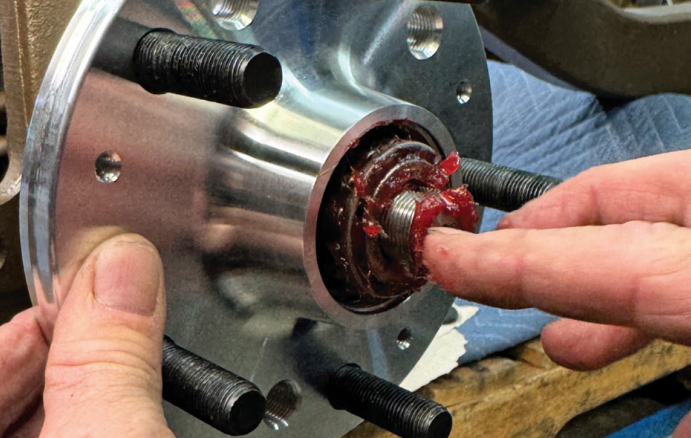 greasing the wheel hub bearings during the 1972 Chevrolet Nova brake assembly process