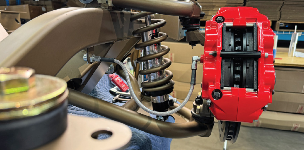 assembled Wilwood red caliper and suspension coil on the 1972 Chevrolet Nova's front axle