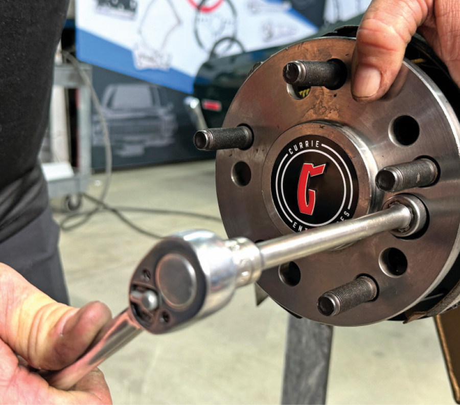 securing hub assembly bolts with a torque wrench during the 1972 Chevrolet Nova brake installation
