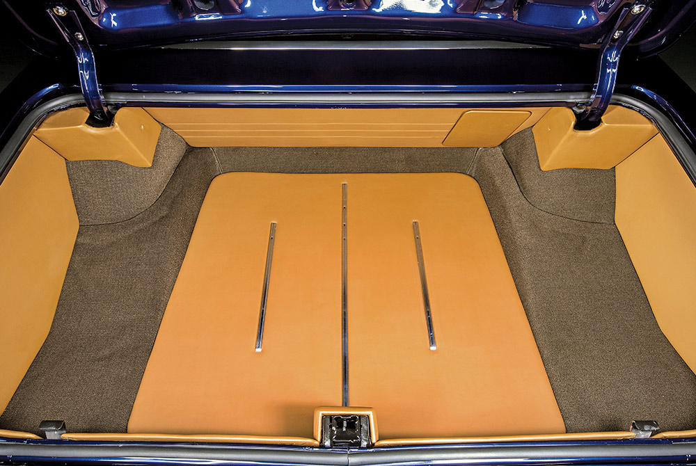 1966 Chevy Nova custom upholstered trunk with tan panels and chrome trim accents