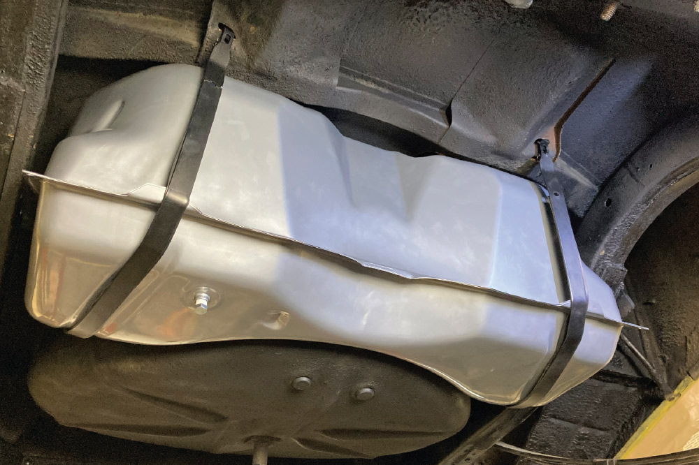 installed aluminum fuel tank secured with straps under vehicle chassis