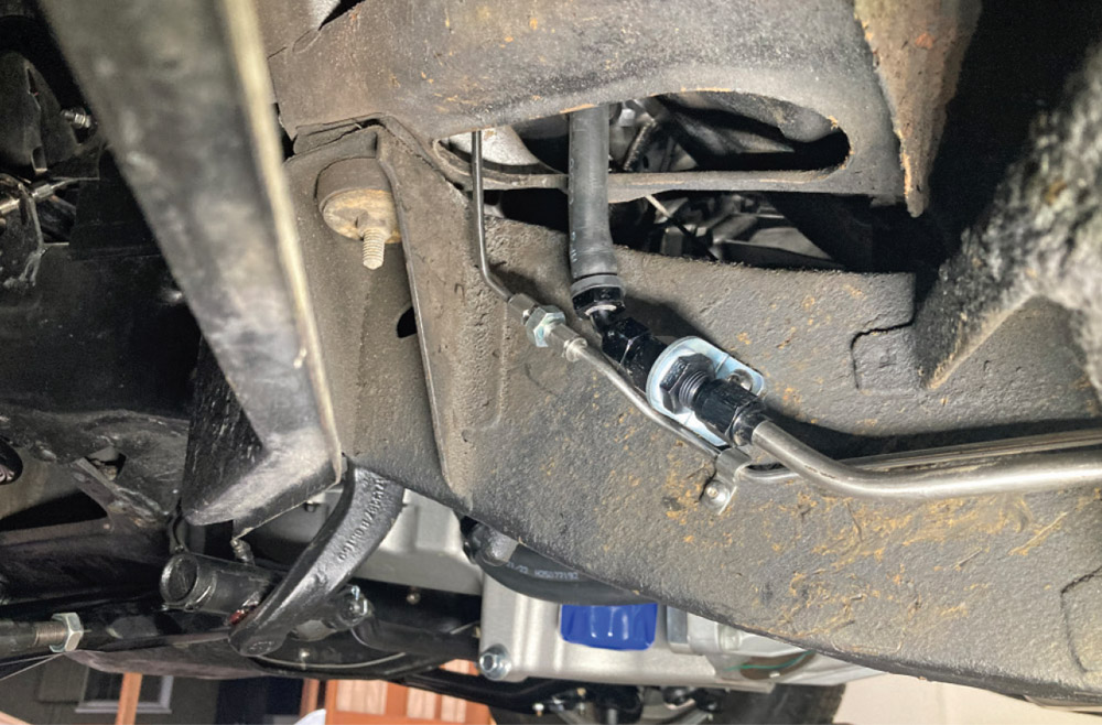 stainless steel fuel line fitted into the frame rail with AN adapter connection