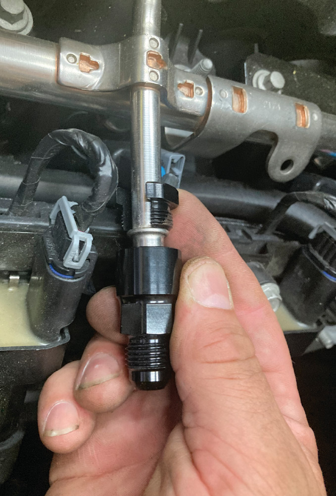 fuel injector rail adapter fitting installed on the high-pressure fuel system