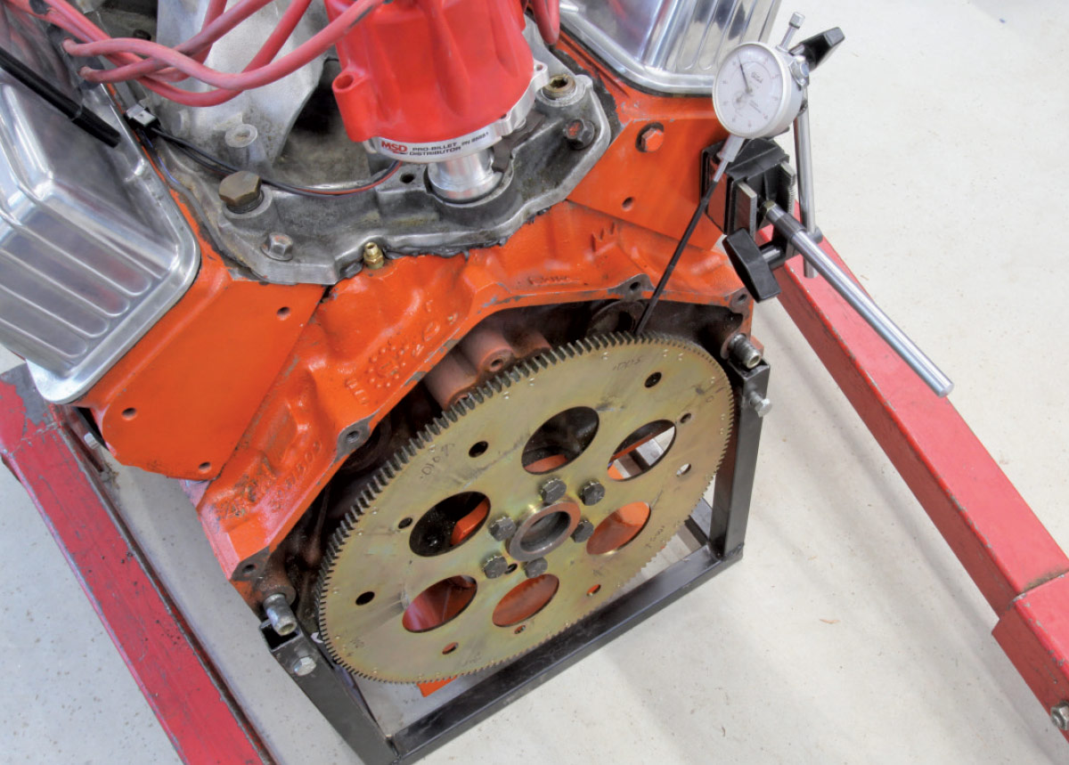 Shim being inserted for alignment between the starter and the bellhousing