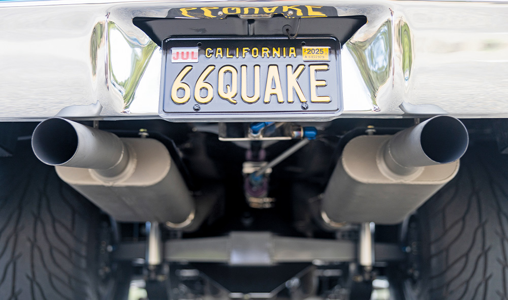 dual rear exhaust tips under a 1966 Chevy Nova with a custom California 66QUAKE license plate