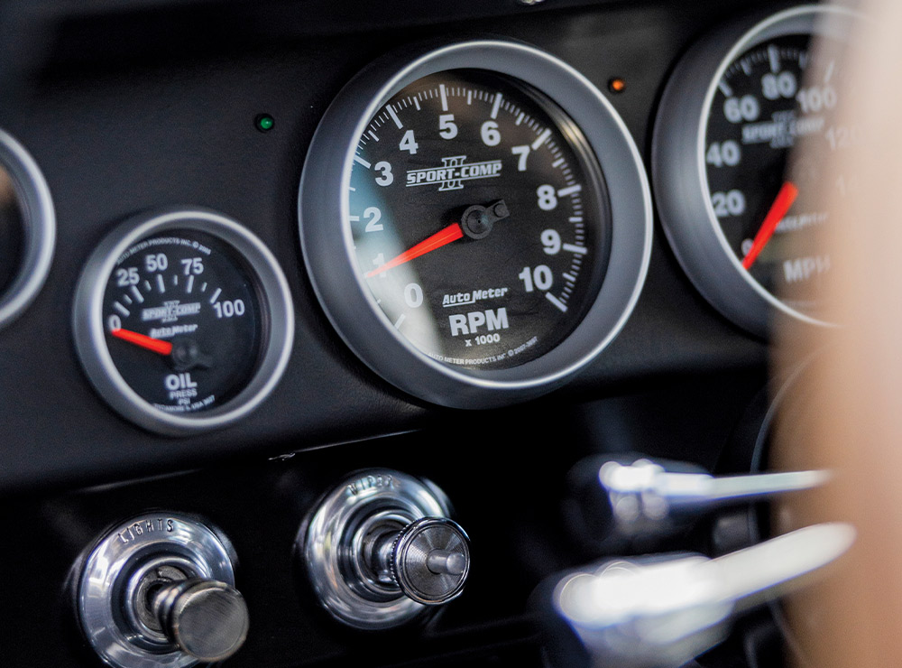 AutoMeter Sport-Comp gauges in 1966 Chevy Nova dash showing RPM, oil pressure, and speedometer for precision monitoring