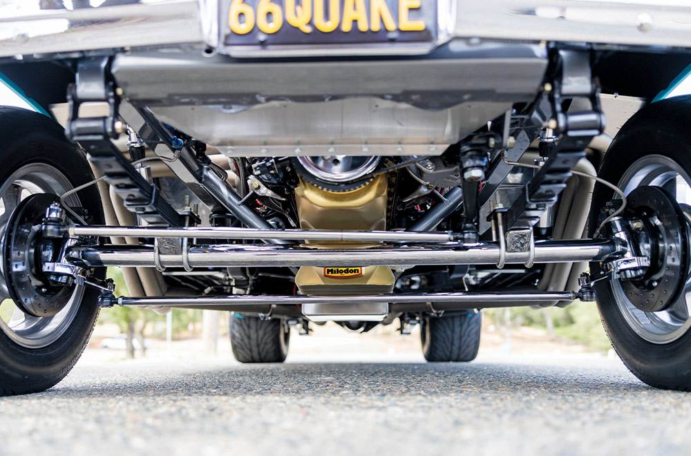 Polished suspension and Milodon oil pan visible under a 1966 Chevy Nova for show-quality and high-performance capability