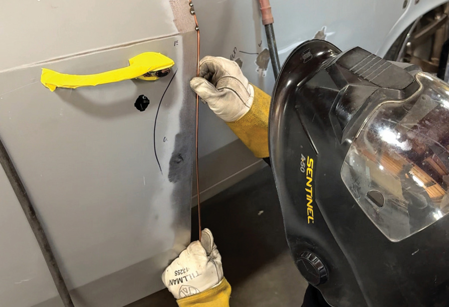 series of tack welds along the door gap, clamped to ensure alignment