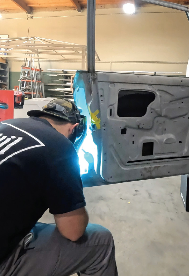 technician welding the inner door panel, ensuring structural integrity