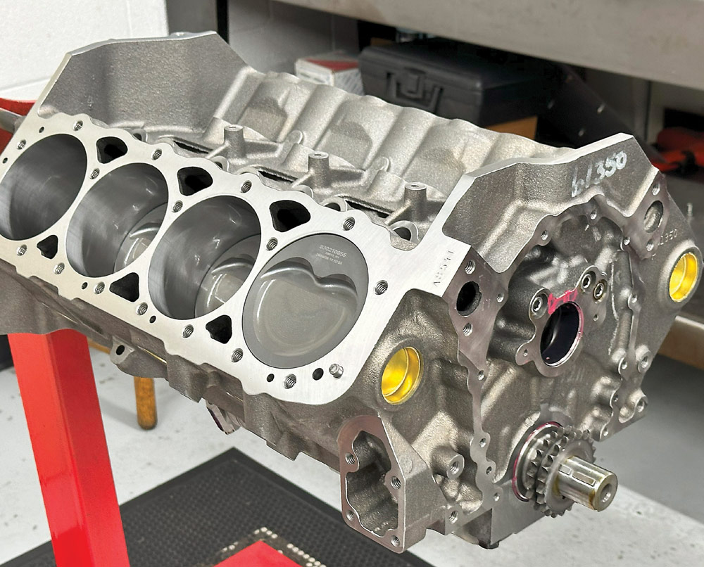 Bare 424 small block engine showing machined cylinders and installed pistons