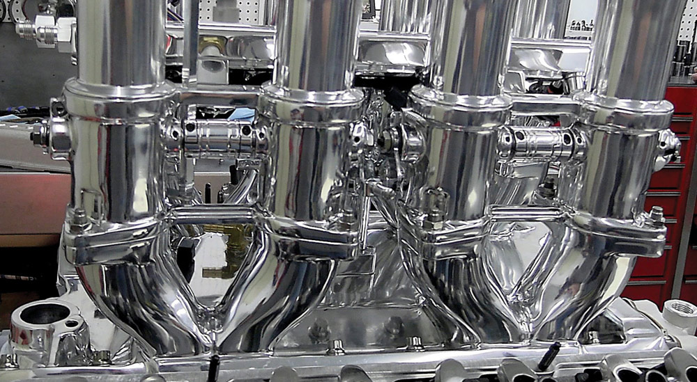Polished intake manifold with connected throttle bodies and precision linkage
