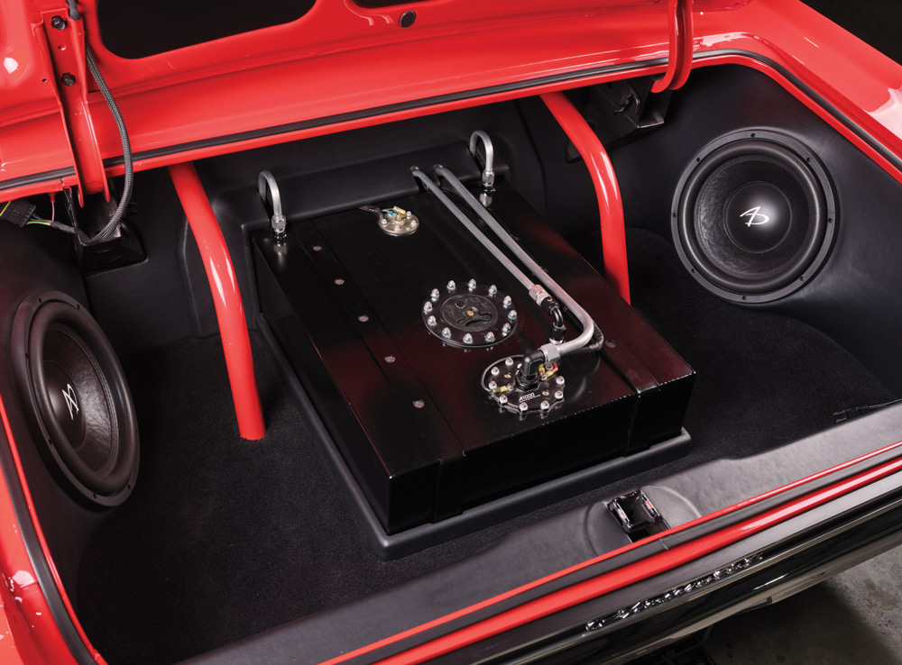 1965 Chevrolet Impala SS trunk with custom fuel cell, subwoofer system, and red roll cage supports