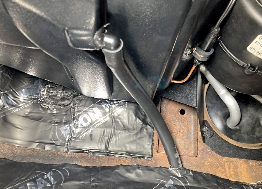 Drain hose routed from the evaporator housing to the floor