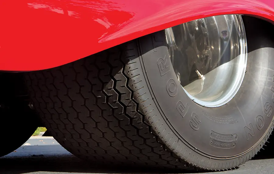 1957 Chevrolet Bel Air rear wheels with massive drag tires and polished deep-dish rims tucked under the fender
