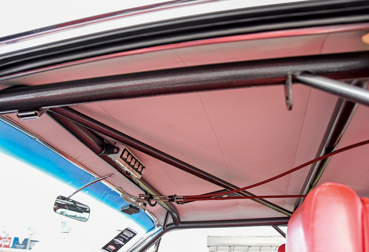 1961 Chevrolet Impala roll cage with overhead reinforcement and switch panel for added structural integrity