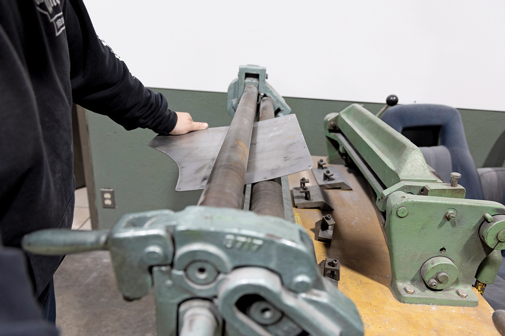 metal panel is shaped on a roller machine to match the contour of the Chevelle's rear quarter panel