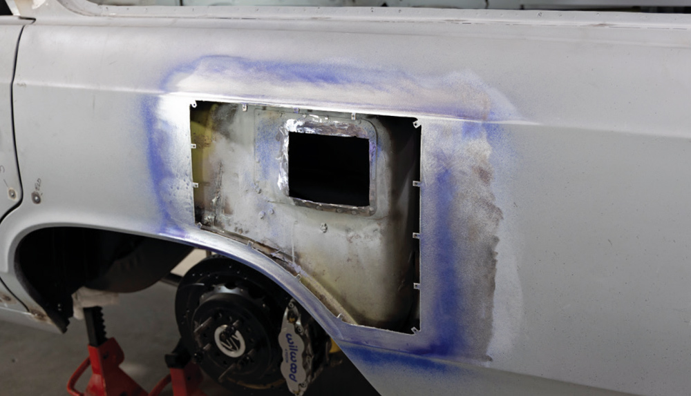 fuel door opening is fully cut out, revealing the inner structure and bracing for the new modification