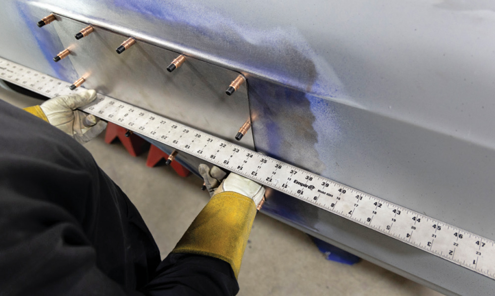straightedge is used to verify proper alignment of the patch panel before final welding